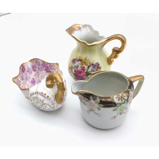 Unmatched collection of vintage and antique hand-painted porcelain pieces, including a yellow floral creamer pitcher...