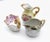 Unmatched collection of vintage and antique hand-painted porcelain pieces, including a yellow floral creamer pitcher...