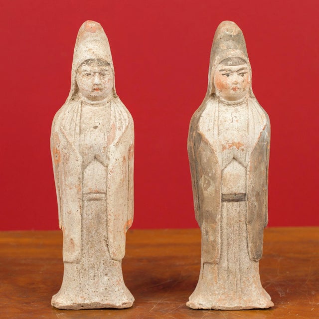 A pair of Qing dynasty 20th century terracotta Chinese hooded priestess sculptures with original paint. Crafted in China...