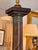 A handsome column lamp in mahogany with applied bronze mounts throughout. The square base has a bronze acanthus-leaf...