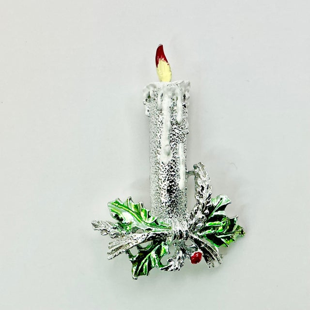A lovely Christmas Brooch from Ancer, Inc. from the 1970s. It features a tall silver candle with yellow-red flame. It sits...