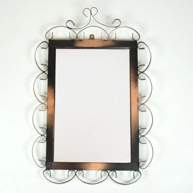 A mirror with a frame made in the metalwork technique from the 1970s, most likely made in Germany. Very good condition,...