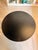Industrial-inspired adjustable dining table featuring a sleek matte black round iron tabletop paired with a bold cast iron...