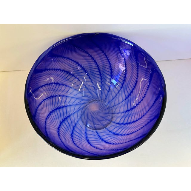 Signed Robinson Scott '91 Art Glass Bowl – Iridescent Purple-Blue with Pink Spiral Pattern This handblown art glass bowl...