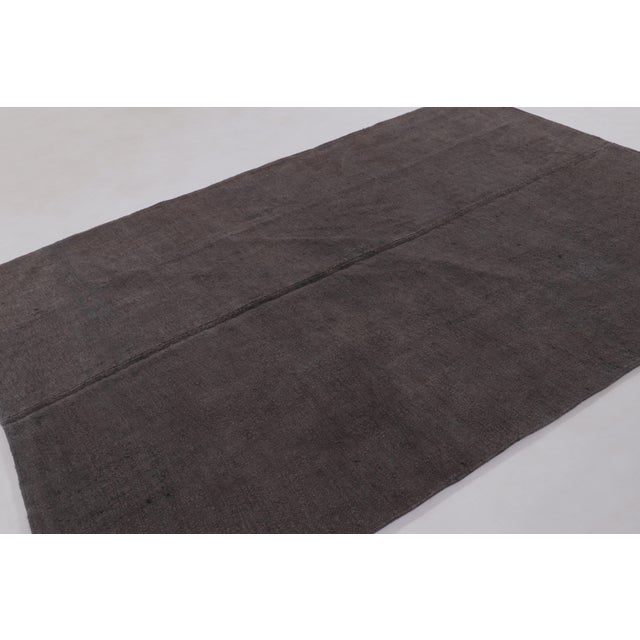 Handwoven in hemp, this 7x10 vintage Anatolian rug, circa 1950–1960, is a refined example of Turkish textile...