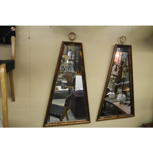 Wonderful pair of trapezoidal frame mirrors often attributed to Tommi Parzinger. The beautiful original finish has been...