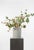 An expressive composition built around blush calla lilies, Queen Anne’s lace, and soft green branching stems. The palette...