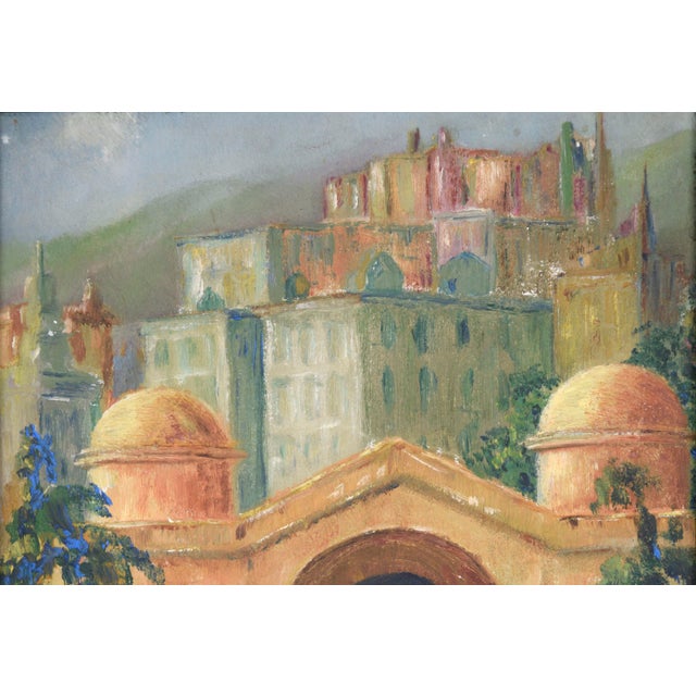 Miniature Cityscape with Flowers and Old Bridge. This miniature cityscape features an arched bridge in front of old...