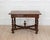 Produced in France during the nineteenth century, this walnut table is worked in the Louis XIII style, a revival of the...