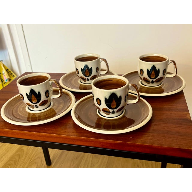 A spectacular set of four cups and four saucers in glazed earthenware, from the belgian manufacturer boch la louvière,...