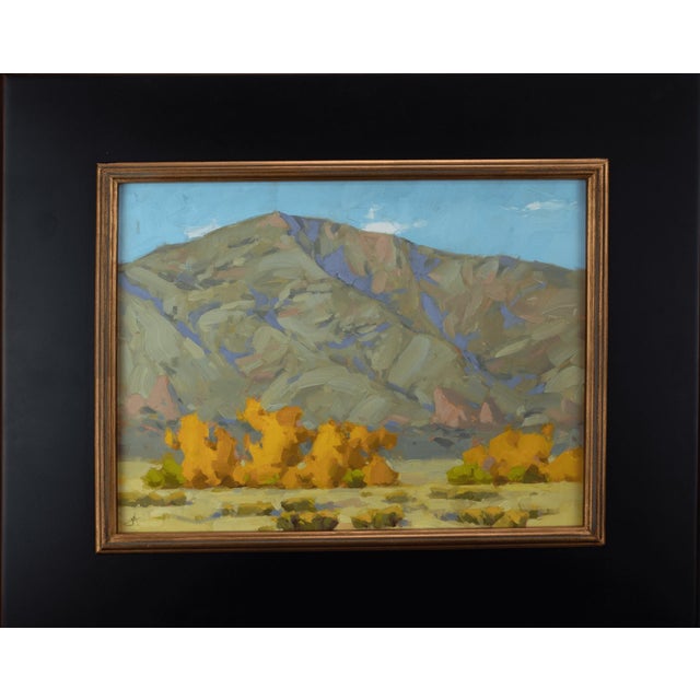 In "Fall Apart," vibrant autumnal trees stand in striking contrast to the rugged mountains in the background, capturing...