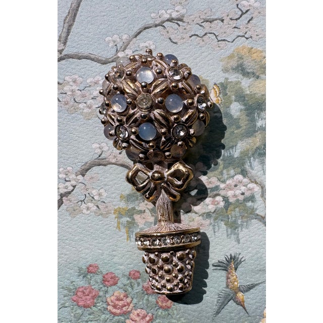 Charming vintage gold tone Trifari topiary brooch with moonstones on a tapestry print, framed. Print is a reproduction on...