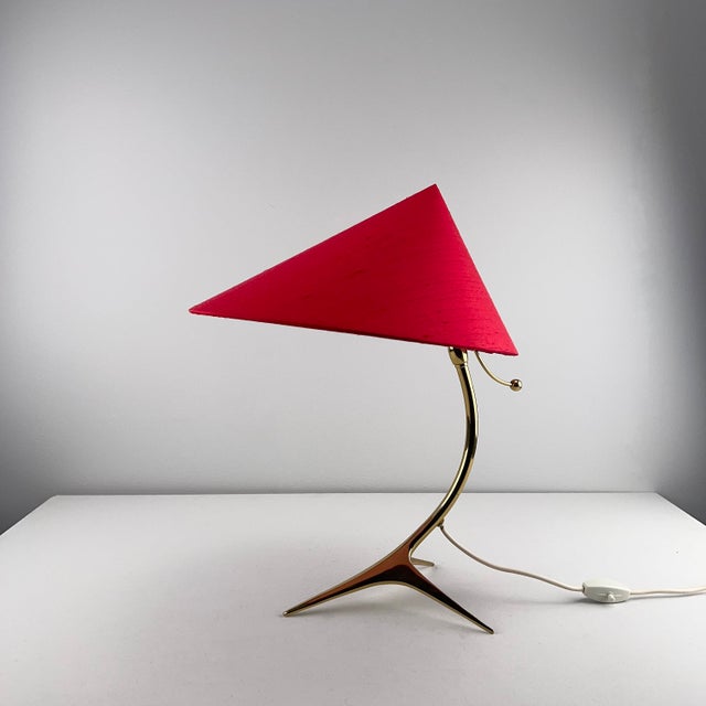 Table lamp with golden crows foot and newly upholstered red silk shade by j. T. Kalmar, 1950s, in flawless conditions....