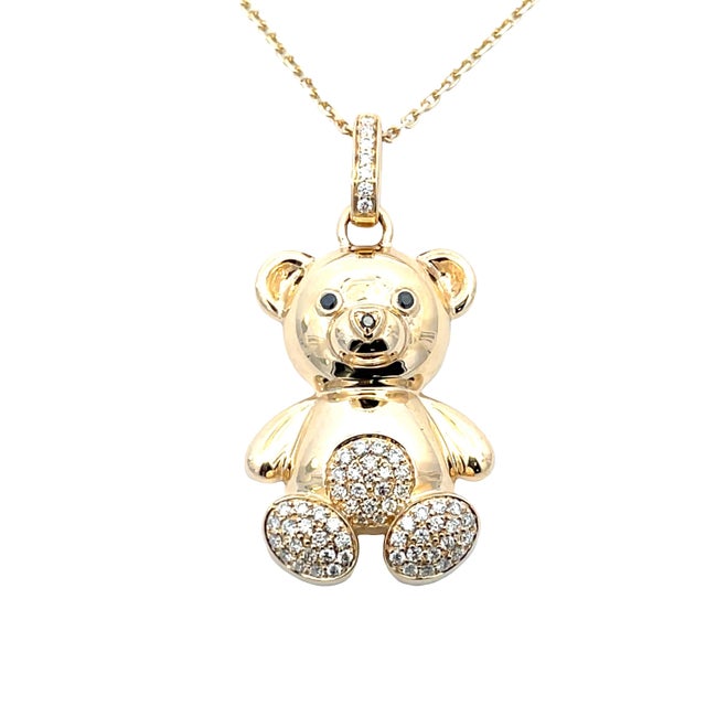 This charming 14K yellow gold teddy bear pendant necklace features a polished teddy bear design accented with 0.30 carat...