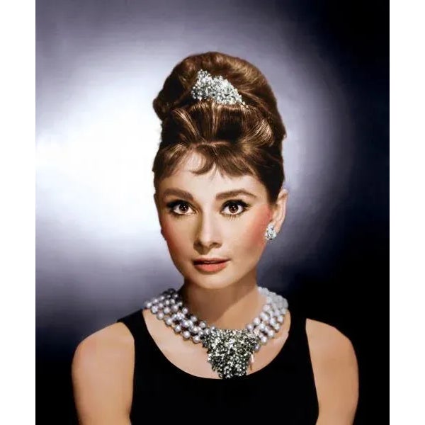 Audrey Hepburn "Breakfast at Tiffany's" This elegant selectively colored promotional portrait features Audrey Hepburn in...