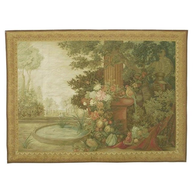 This beautiful vintage European tapestry presents an elaborate garden landscape filled with lush vegetation, colorful...