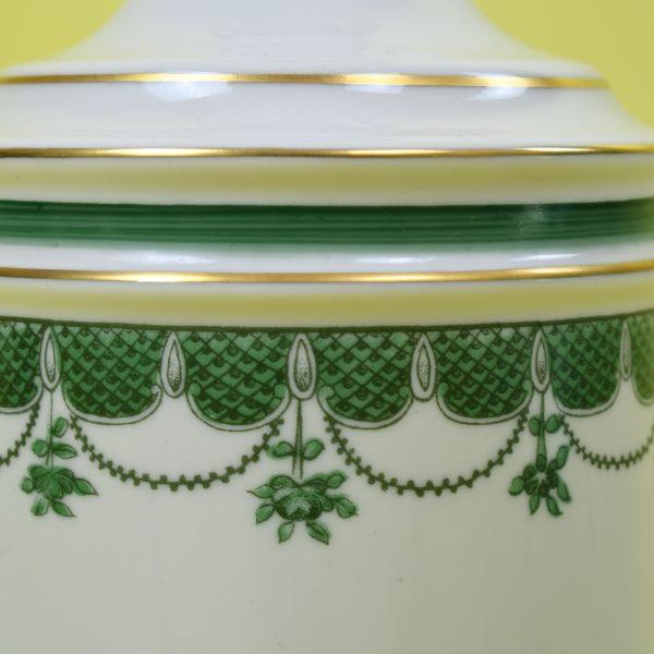 A classic pair of colonial-style table lamps in green and ivory, with timeless turned silhouettes. The two-tone finish...