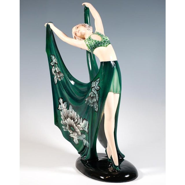 Delicate goldscheider art déco ceramic figurine of the late 1930s: gracefully posing dancer in a dark green costume:...