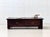 A characterful coffee table crafted from solid wood in a dark brown finish. The heavy, low construction, wide frame, and...