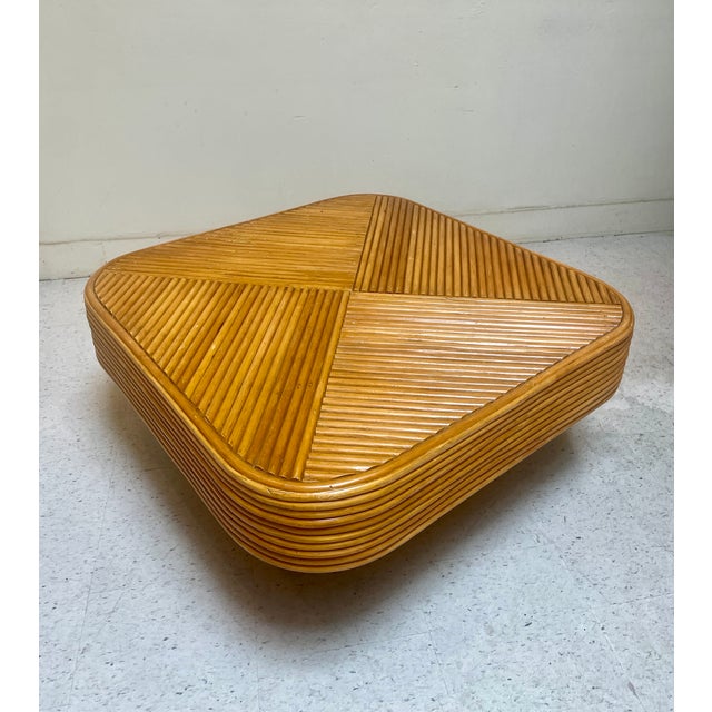 This piece is a pencil reed rattan coffee table which can also be used as an end table. Stair stepped stacked rattan....
