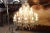 Beautiful and refined Italian 1930s chandelier with 18 bulbs. The lights are arranged on two floors. In patinated bronze...
