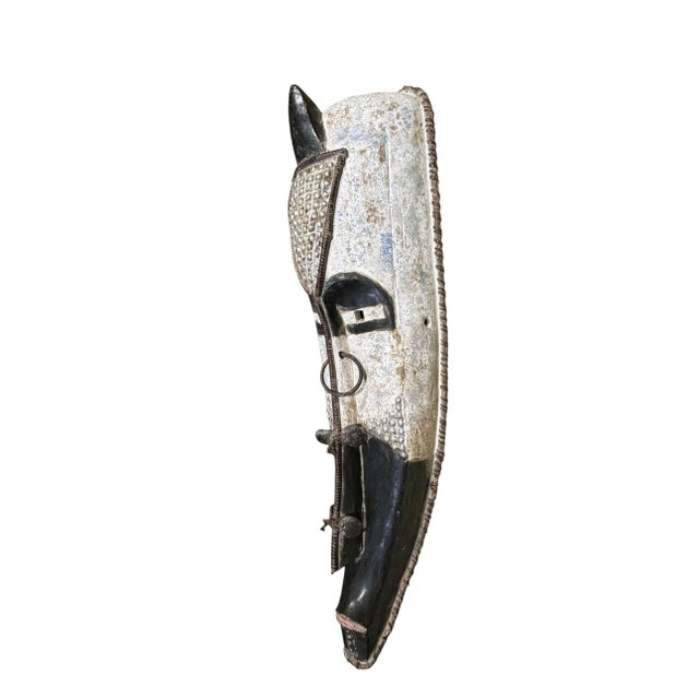 Superb vintage Fang mask carved from a single piece of wood, featuring an elongated heart-shaped face rendered in striking...