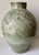 This gorgeous and rare vintage Chinese celadon vase features abstract incised designs and is mounted on a hand-carved...