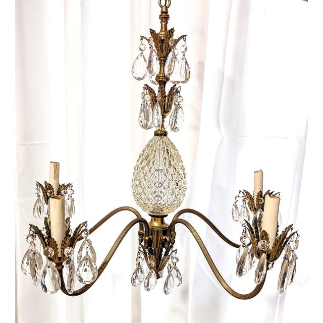 This ornate 5-light chandelier is estimated to be from the mid 20th century and of the Hollywood Regency style. It...
