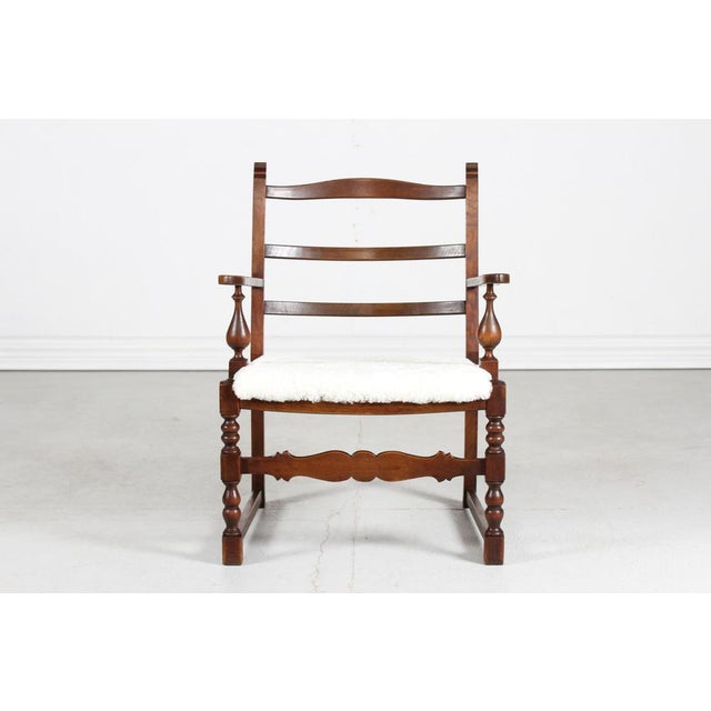 Danish handcrafted lounge chair of solid dark oak, made in the 1940´s by a Danish cabinetmaker. The chair has a sculptural...