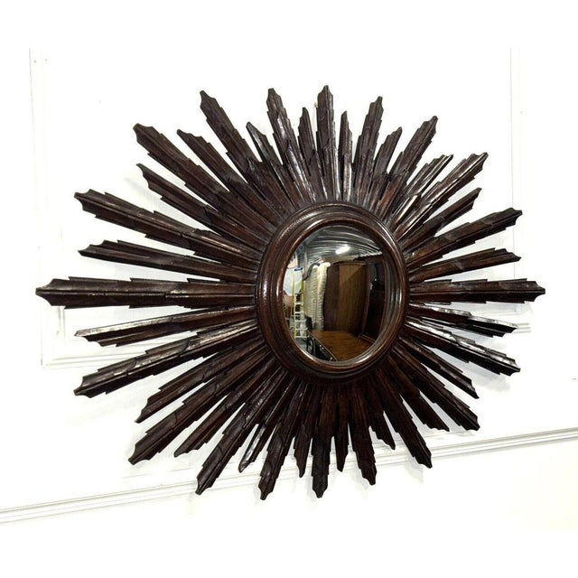 Rare Spanish Wooden Sunburst Wall Mirror from Circa 1940. Is a striking piece that showcases a unique blend of...