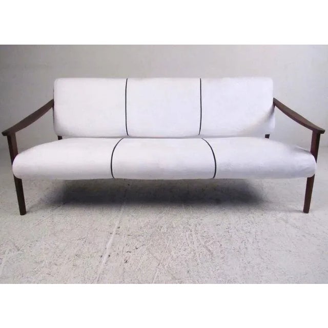 This beautiful Mid-Century style sofa makes a stylish addition to any interior and offers seating for three with sculpted...