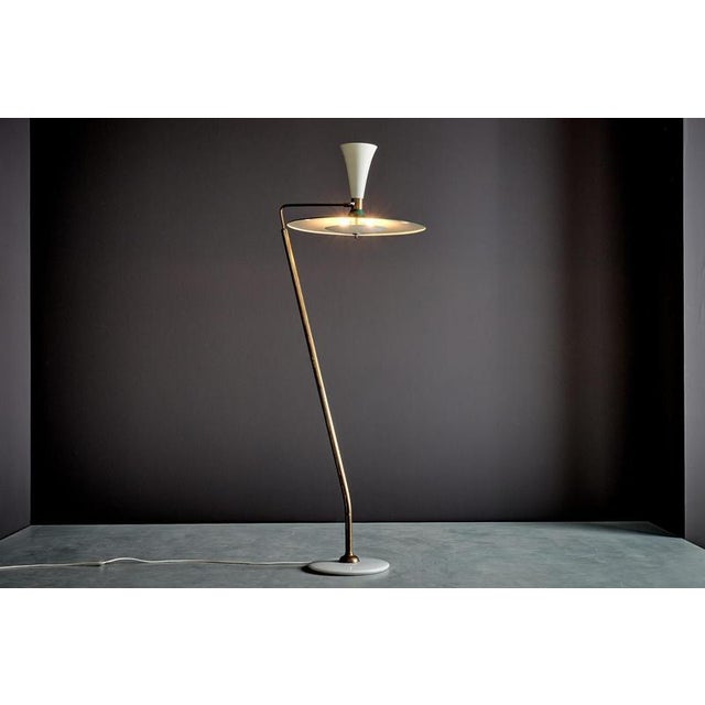 Elegant Italian floor lamp with a brass stem, white marble base and green metal shade. The lamp has a sculptural, angled...