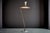 Elegant Italian floor lamp with a brass stem, white marble base and green metal shade. The lamp has a sculptural, angled...