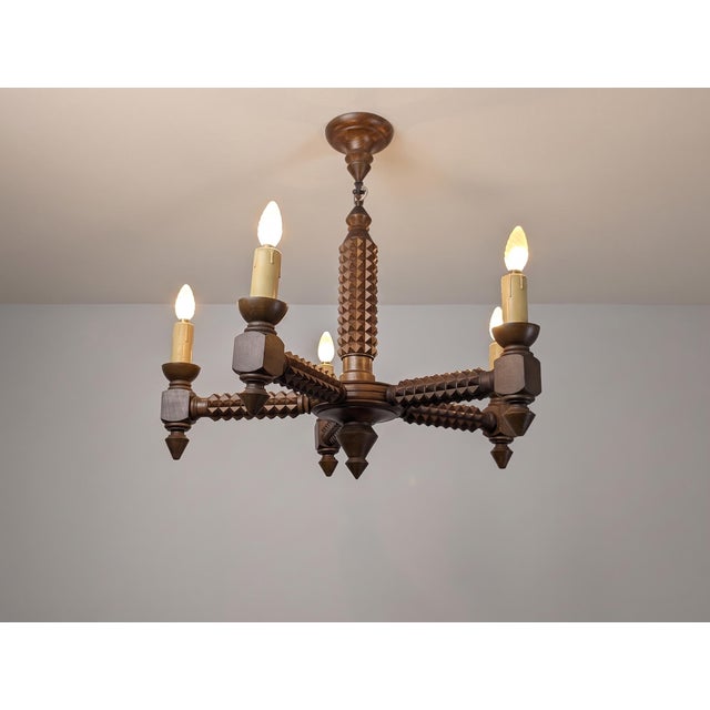 This chandelier reflects the Brutalist sensibility found in French design of the 1940s, carved in the sculptural style...