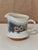 A charming vintage Goebel Burgund creamer featuring a country-inspired floral design with blue and yellow blossoms, gray...
