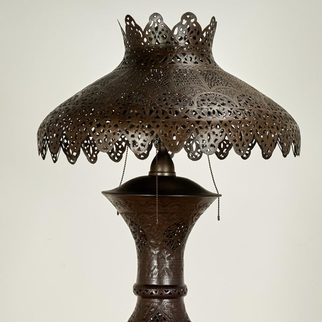 Enchanting antique Moroccan floor lamp and matching shade handcrafted in perforated brass, in Moorish form, with floral...