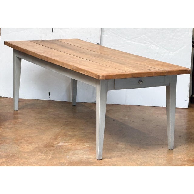 A handsome large French rectangular farmhouse table from the 19th century, featuring a three-plank top of patinated beech...