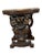 Ornately carved cherub console tables featuring putti and intricate fruit motifs on richly finished wood. Measurements are...