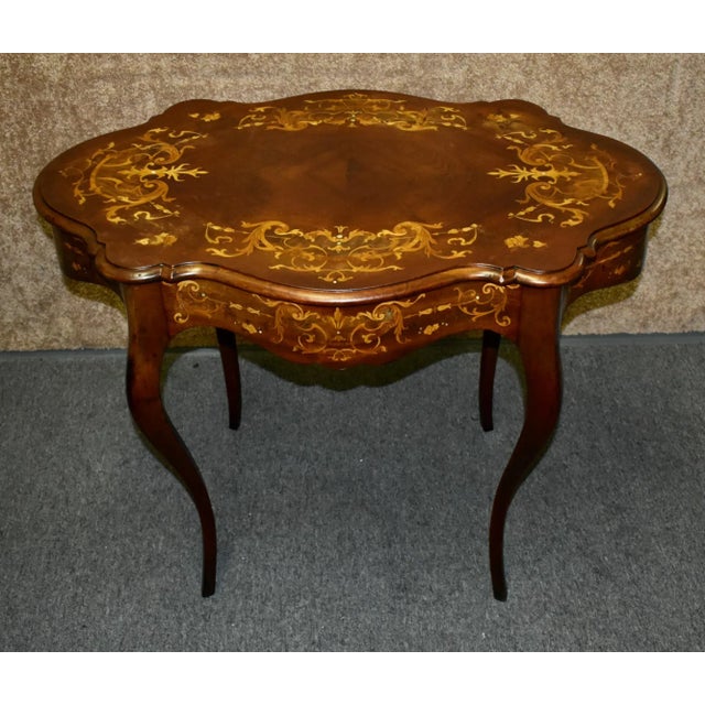Antique (1900s) Turtle Top Shaped Table has a Renaissance Revival/ Victorian Style. The Wood is Mahogany. Inlaid Mahogany...