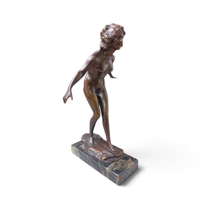 - Bronze nude young woman leaning forward into the wind on a rocky base, arms thrown wide and back - Western Europe, most...