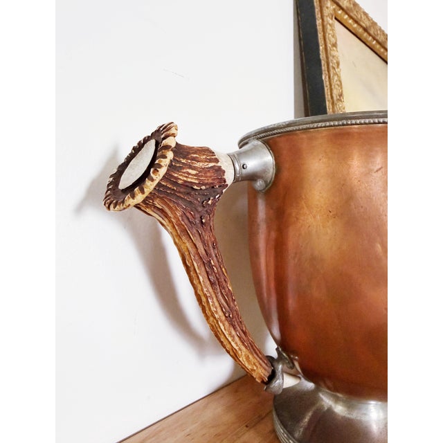 A beautiful antique circa 1910s copper trophy with deer antler handles, engraved to read: 1st Prize Black Langshans...