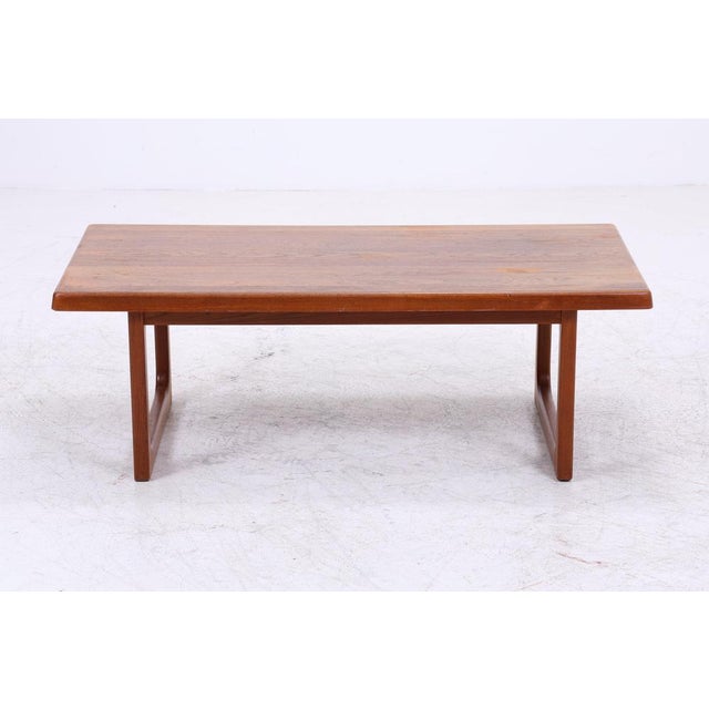 Vintage coffee table by Niels Bach in classic 1960s Danish design. The solid tabletop with gently rounded edges and the...