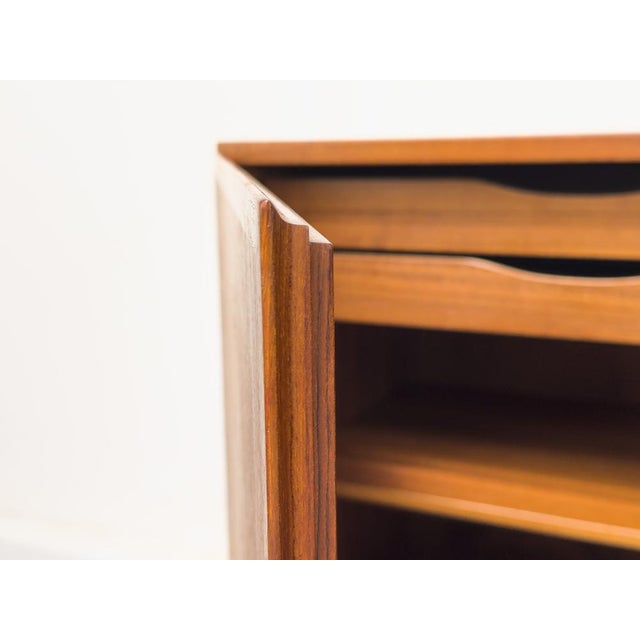 Teak sideboard with two handleless cabinet doors featuring solid wood edges. Beautiful grain and high-quality...