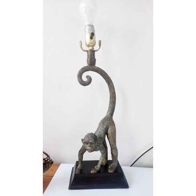A striking vintage figural monkey table lamp crafted in cast metal with a warm bronze-tone patinated finish. The...