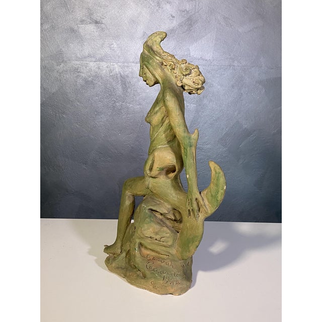 Terracotta sculpture by Edoardo Ceccardi, "Metamorphosis of the Mermaid" (1974). A work that bears the breath of time: its...