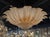 The Gold "Granola" Murano Glass Flush Mount Chandelier is a luxurious and elegant lighting fixture that adds a touch of...