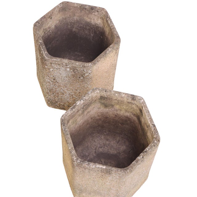 A striking pair of French Modernist cast stone planters, each of hexagonal form with a distinctive textured, pebbled...