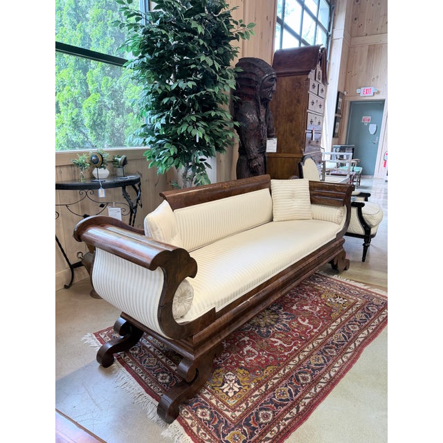 An exceptional American Empire sofa dating to the 1830s, showcasing the bold scale, sculptural forms, and commanding...