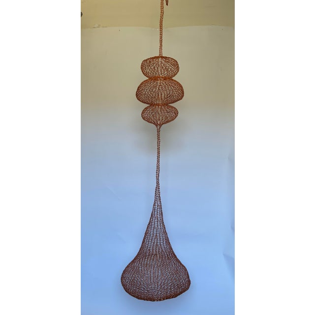 A striking monumental handwoven copper wire hanging sculpture in the style of Ruth Asawa, showcasing the delicate...