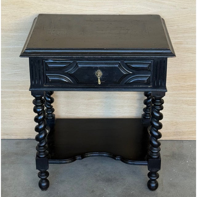 20th century pair of solid carved Spanish nightstands with Solomonic columns and carved drawers. The pieces have a low...